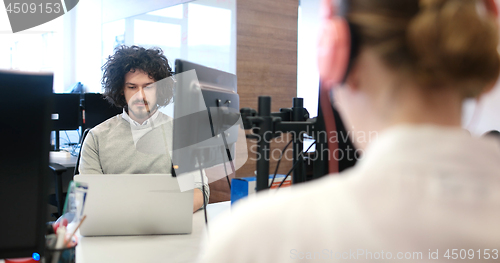 Image of businessman working using a laptop in startup office