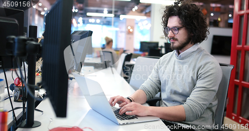 Image of businessman working using a laptop in startup office