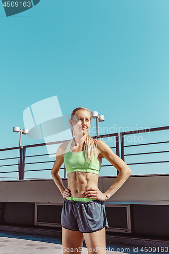 Image of Fit fitness woman posing at city