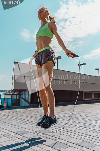 Image of Fit fitness woman doing fitness exercises outdoors