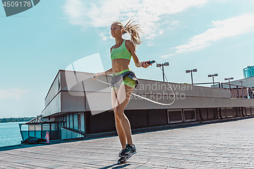 Image of Fit fitness woman doing fitness exercises outdoors