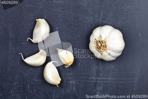 Image of Fresh raw organic garlic on black board.