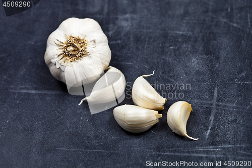 Image of Fresh raw organic garlic on black board.