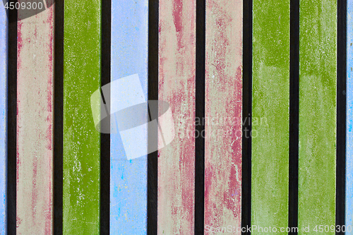 Image of Colorful blue, pink and green wooden aged plank wall.