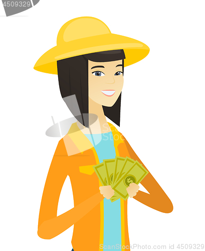 Image of Young happy asian farmer holding money.