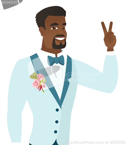 Image of Young african groom showing the victory gesture.
