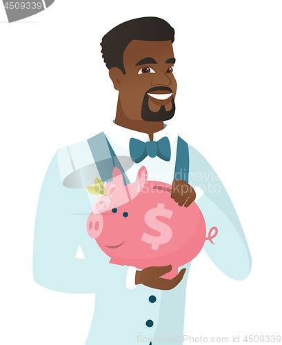 Image of African-american groom holding a piggy bank.