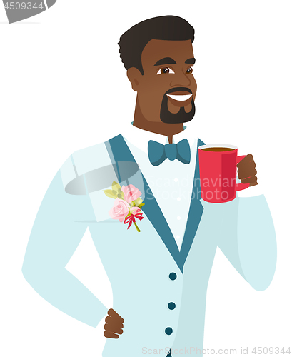 Image of Young african-american groom holding cup of coffee