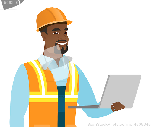 Image of African-american builder using laptop.