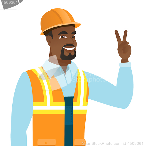 Image of African-american builder showing victory gesture.