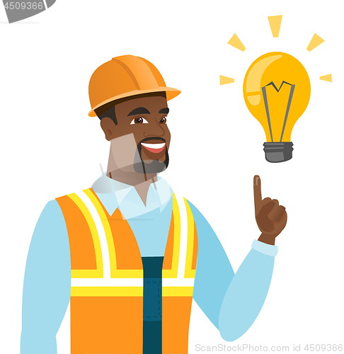 Image of African-american builder pointing at light bulb.