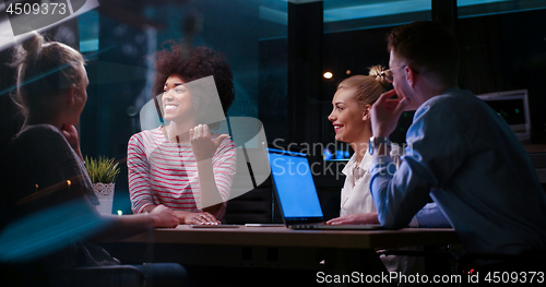 Image of Multiethnic startup business team in night office
