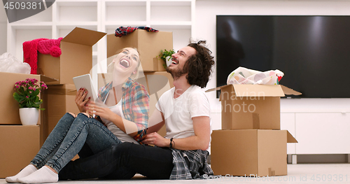 Image of young couple moving  in new house