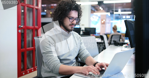 Image of businessman working using a laptop in startup office