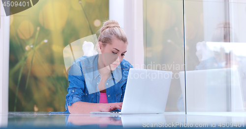Image of young women using laptop computer on the floor