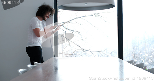 Image of young man using a tablet at home