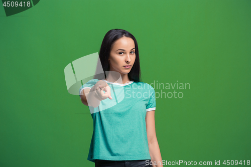 Image of The overbearing business woman point you and want you, half length closeup portrait on green background.