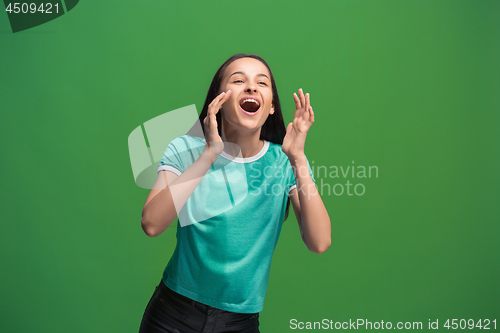 Image of Isolated on pink young casual woman shouting at studio