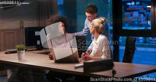 Image of Multiethnic startup business team in night office