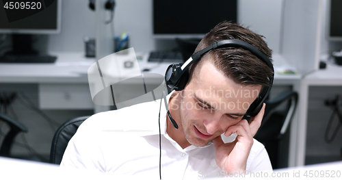 Image of male call centre operator doing his job