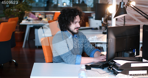 Image of businessman working using a computer in startup office