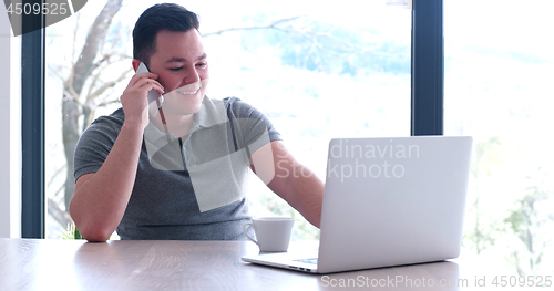 Image of businessman working using a laptop in startup office