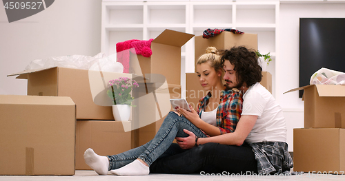 Image of young couple moving  in new house