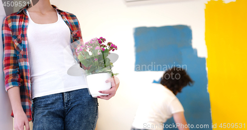 Image of happy young couple doing home renovations