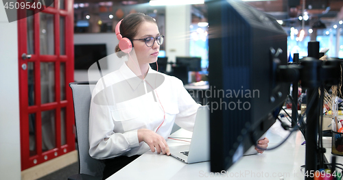 Image of businesswoman using a laptop in startup office