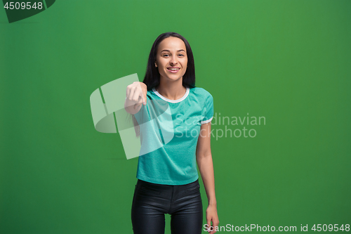 Image of The happy business woman point you and want you, half length closeup portrait on green background.