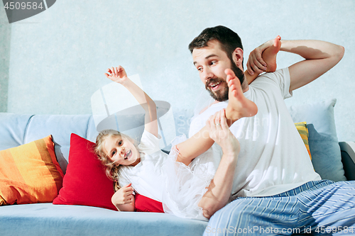 Image of Father and his six years kid girl at home