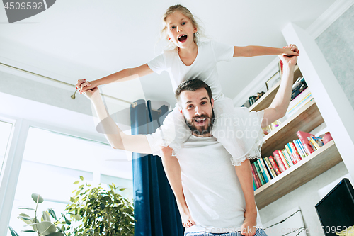 Image of Father and his six years kid girl at home