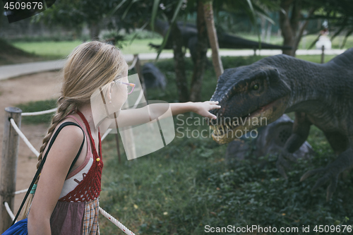 Image of little girl playing in the adventure dino park.