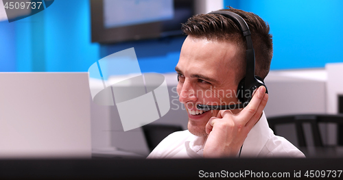 Image of male call centre operator doing his job