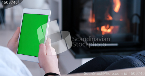 Image of woman on sofa using tablet computer
