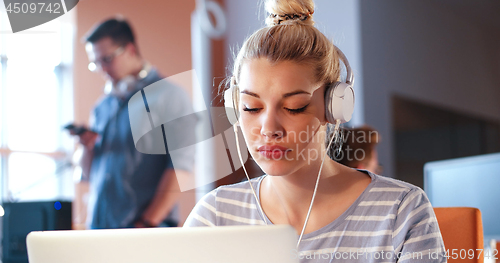 Image of businesswoman using a laptop in startup office