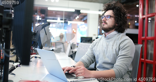 Image of businessman working using a laptop in startup office