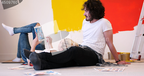 Image of Happy young couple relaxing after painting