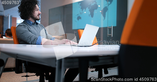 Image of businessman working using a laptop in startup office