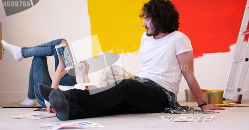 Image of Happy young couple relaxing after painting
