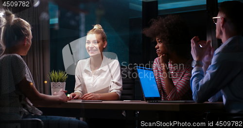 Image of Multiethnic startup business team in night office