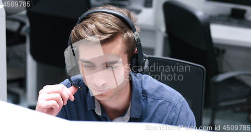 Image of male call centre operator doing his job