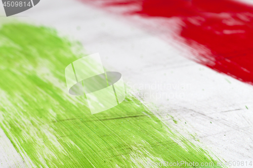 Image of  Italian flag painted with  brush strokes on white background.