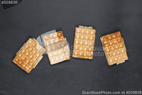 Image of Belgium waffers on black board background.