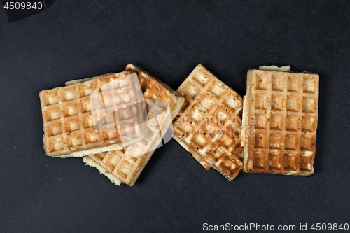 Image of Belgium waffers on black board background.