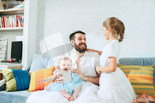 Image of The happy father and his baby daughters at home