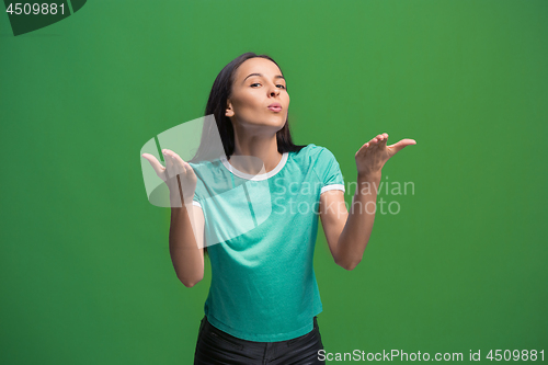 Image of Portrait of attractive cute girl with bright makeup with kiss isolated over green background