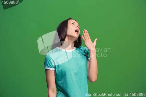 Image of Beautiful bored woman bored isolated on green background