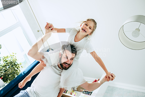 Image of Father and his six years kid girl at home