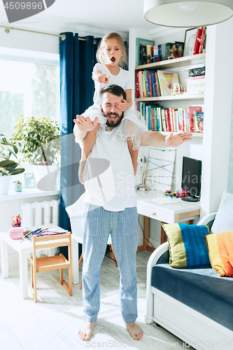 Image of Father and his six years kid girl at home